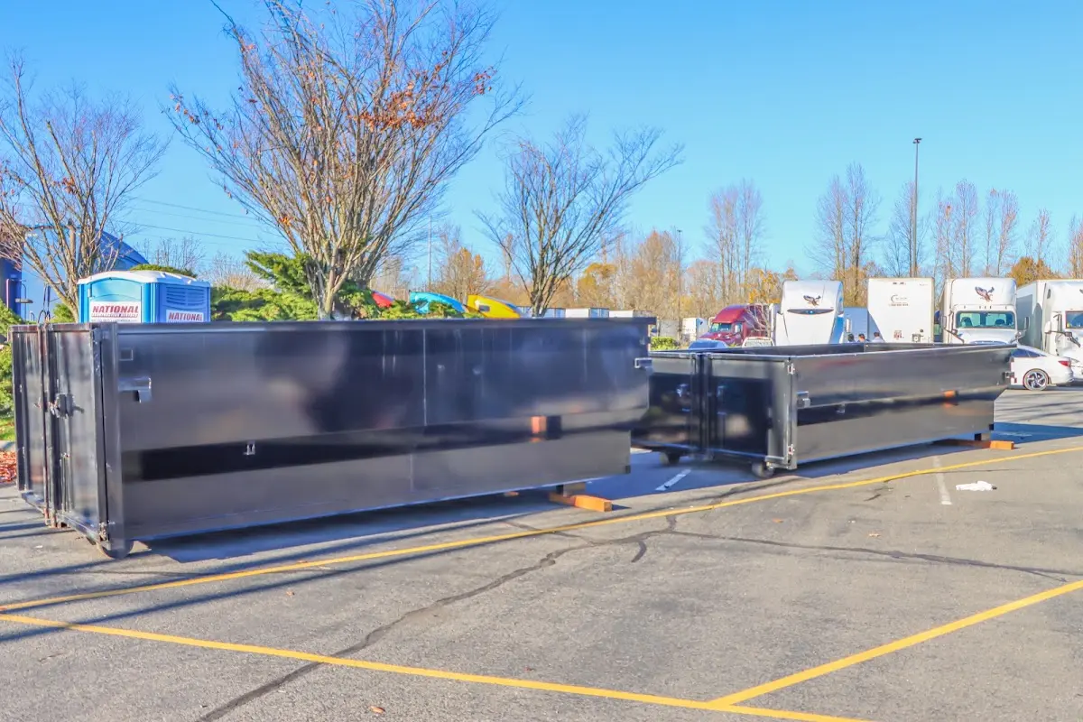 Professional dumpster rental service with roll-off container on residential driveway in Reedley